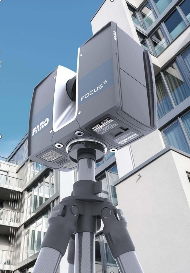 FARO Focus S 3D laser scanner on a tripod in front of a modern building